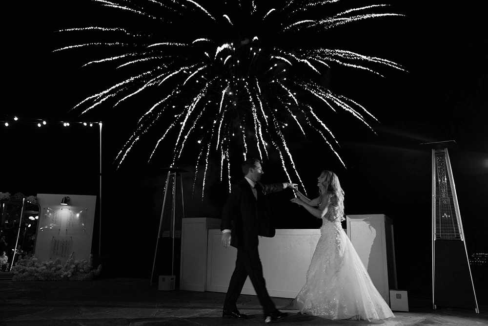 Couple dancing under fireworks at wedding reception