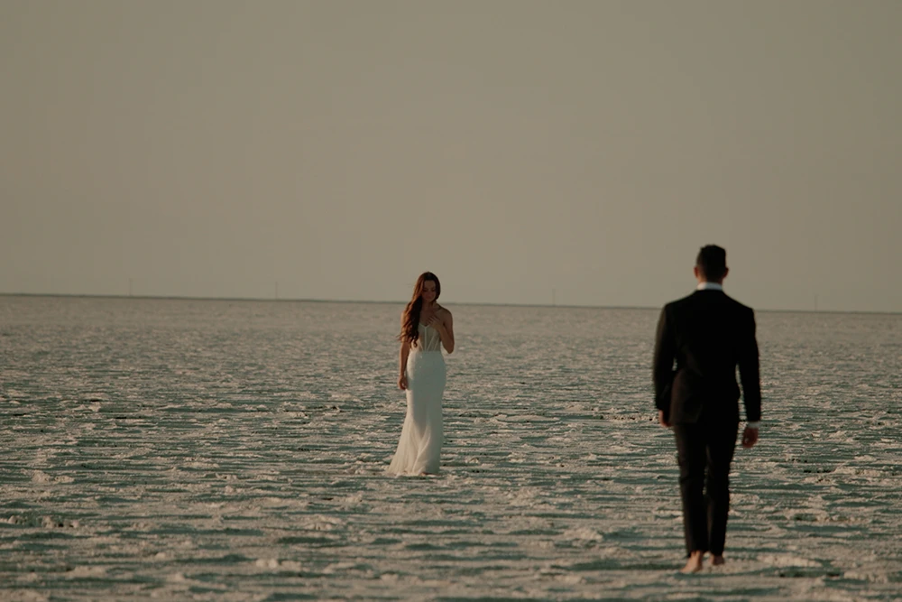 Bride and groom walking at sunset overlooking the river at The Broadmoor, Colorado Springs